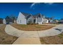 Pleasant neighborhood street view featuring sidewalks and meticulously maintained homes with lush landscaping at 317 Catawba Branch Way, Moncks Corner, SC 29461