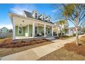 Charming home with a spacious front porch, perfect for relaxing in a beautiful setting at 411 Watergrass Way, Summerville, SC 29485