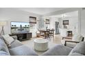 Open-concept living room featuring modern furnishings and a view into the bright eat-in kitchen at 415 Parkdale Dr # 8A, Charleston, SC 29414