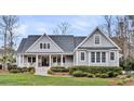 Lovely home with a welcoming front porch, well-maintained landscaping, and classic architectural details at 4162 Ten Shillings Way, Hollywood, SC 29470