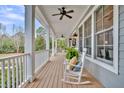 Inviting front porch featuring comfortable seating, ceiling fans, and views of the surrounding landscape at 4162 Ten Shillings Way, Hollywood, SC 29470