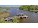 Beautiful wooden dock featuring boat lift with cover, walkway, and adjacent calm waterway at 4385 Ten Shillings Way, Hollywood, SC 29470