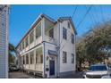 Two-story home featuring double porches with white railings and classic details at 53 America St, Charleston, SC 29403