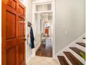 Bright foyer featuring a wooden front door and views into the living room at 53 America St, Charleston, SC 29403