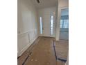 Bright entryway featuring white walls, decorative trim, and a glass-paneled front door at 586 Marsh Cove Cir, Summerville, SC 29486
