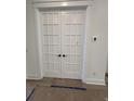 White french doors with glass panes lead to a home office at 586 Marsh Cove Cir, Summerville, SC 29486