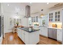 Bright kitchen boasts white cabinets, stainless appliances, and a center island at 8834 Palmetto Rd, Edisto Island, SC 29438