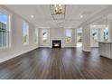 Bright living room featuring hardwood floors, fireplace, coffered ceiling, and large windows at 117 Grange Cir, Summerville, SC 29486