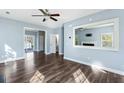 Spacious living room featuring hardwood floors, light blue walls, and a large mirror at 129 E Hartwick Ln, Goose Creek, SC 29445