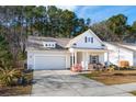 Inviting single-story home with a two-car garage and a cozy front porch at 1601 Thin Pine Dr, Johns Island, SC 29455