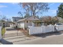 Exterior shot showcasing the home's facade, gated yard, and a carport on the side at 1987 Echo Ave, North Charleston, SC 29405