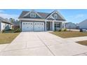 Inviting craftsman-style home with a two-car garage, well-maintained lawn, and charming architectural details at 224 Fiddleback Dr, Summerville, SC 29486