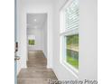 Inviting hallway with wood-look floors, leading to bright spaces with natural light and modern finishes at 224 Night Heron St # 629, Summerville, SC 29486