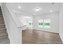 Open-concept living area with light-colored wood floors and plenty of natural light from large windows at 224 Night Heron St # 629, Summerville, SC 29486
