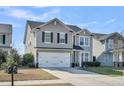 Charming two-story home with gray siding, black shutters, a red door, and a two-car garage at 231 Laurel Crest Way, Summerville, SC 29486