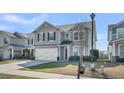 Charming two-story home with gray siding, black shutters, a red door, and a two-car garage at 231 Laurel Crest Way, Summerville, SC 29486
