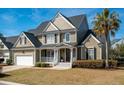 Charming two-story home with a well-manicured lawn, inviting porch, and attached two-car garage at 2972 Riverwood Dr, Mount Pleasant, SC 29466