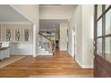 Warm and inviting foyer features hardwood floors, a staircase, and views into the dining and living areas at 2972 Riverwood Dr, Mount Pleasant, SC 29466