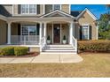 Inviting front porch with classic white columns and railings, leading to a dark wood front door at 2972 Riverwood Dr, Mount Pleasant, SC 29466