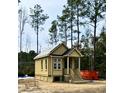 Cozy, quaint home with a welcoming front porch, classic design, and serene surroundings at 3102 Hailey Ct, McClellanville, SC 29458