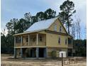 Elegant raised home featuring a spacious porch, elevated design, and classic architectural details at 3102 Hailey Ct, McClellanville, SC 29458
