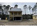Charming raised home with a spacious porch, elevated design, and inviting architectural details at 3102 Hailey Ct, McClellanville, SC 29458