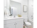 Clean white bathroom with a white vanity, a large mirror, and a shower over the tub at 315 Pine Crest View Dr, Summerville, SC 29486