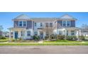 Well-maintained two-story townhomes with inviting front lawns and colorful landscaping at 3941 Four Poles Park Dr, North Charleston, SC 29405