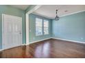 Inviting living room with hardwood floors, neutral paint, crown molding, and bright natural light at 429 Cherrybark Oak St, Summerville, SC 29486