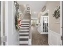 Inviting foyer with wood-look floors, staircase, and decorative accents that welcomes you into a beautiful home at 433 Cedarview Rd, Summerville, SC 29486