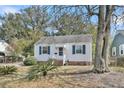 Charming single-story home with white siding, blue shutters and lush front landscaping at 4816 Chesterfield Rd, North Charleston, SC 29405