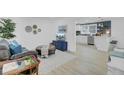 Open-concept living space with modern decor and seamless flow to kitchen area at 5332 Parkside Dr, North Charleston, SC 29405