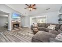 Comfortable living room boasts a brick fireplace and a sectional couch at 613 Salterton St, Summerville, SC 29485