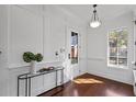 Bright foyer with elegant woodwork, decorative console table and a view to the outside at 720 Island Park Dr # 104, Charleston, SC 29492
