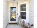 Front door and entry with decorative elements. Shows the entry to be well lit with a security camera at 7426 Painted Bunting Way, Hanahan, SC 29410