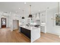 Bright, modern kitchen with a waterfall island, sleek cabinetry, and stainless steel appliances at 806 Jungle Rd, Edisto Island, SC 29438