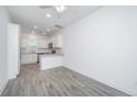 Bright living room features gray flooring and a view of the modern kitchen at 9207 Bowen Corner Ave, Hanahan, SC 29410