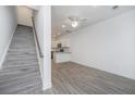 Bright living room features gray flooring, a staircase, and a view of the modern kitchen at 9207 Bowen Corner Ave, Hanahan, SC 29410