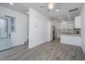 Bright living room features gray flooring, a staircase, an entry door, and a modern kitchen at 9207 Bowen Corner Ave, Hanahan, SC 29410