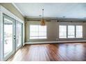 Open living room features hardwood floors, large windows, and a sliding glass door at 109 Walnut Creek Rd, Charleston, SC 29414