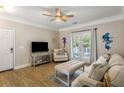 Bright living room featuring comfortable furniture, a ceiling fan, and access to a balcony at 1204 Basildon Rd, Mount Pleasant, SC 29466