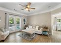 Bright living room with a ceiling fan, a comfortable sofa, and French doors to the balcony at 1204 Basildon Rd, Mount Pleasant, SC 29466