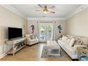 Inviting living room with a ceiling fan, a comfortable sofa, and French doors to the balcony at 1204 Basildon Rd, Mount Pleasant, SC 29466