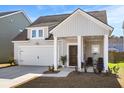 Attractive home featuring an attached garage, welcoming front porch, and tidy landscaping at 136 Post Mill Dr, Summerville, SC 29485