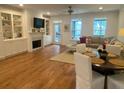 Inviting living room with hardwood floors, built-in shelving and cozy fireplace at 148 Cowrie Ct, Mount Pleasant, SC 29464