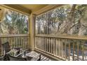 Screened in balcony featuring seating and view of surrounding tree canopy at 1600 Long Grove Dr # 1727, Mount Pleasant, SC 29464