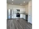 Modern kitchen features stainless steel appliances, granite countertops, and ample white cabinetry at 2204 Scarlett Maple St, Summerville, SC 29486