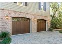 Attached two-car garage with brick facade and beautiful paved driveway at 176 Marsh Hawk Ln, Kiawah Island, SC 29455