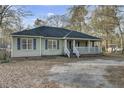 The home has an inviting front porch with white railings, creating a cozy and classic curb appeal at 223 Fox Field Rd, Walterboro, SC 29488