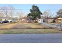 A cozy single-story home with brick accents, a driveway, and a peaceful neighborhood setting at 228 Jean Wells Dr, Goose Creek, SC 29445